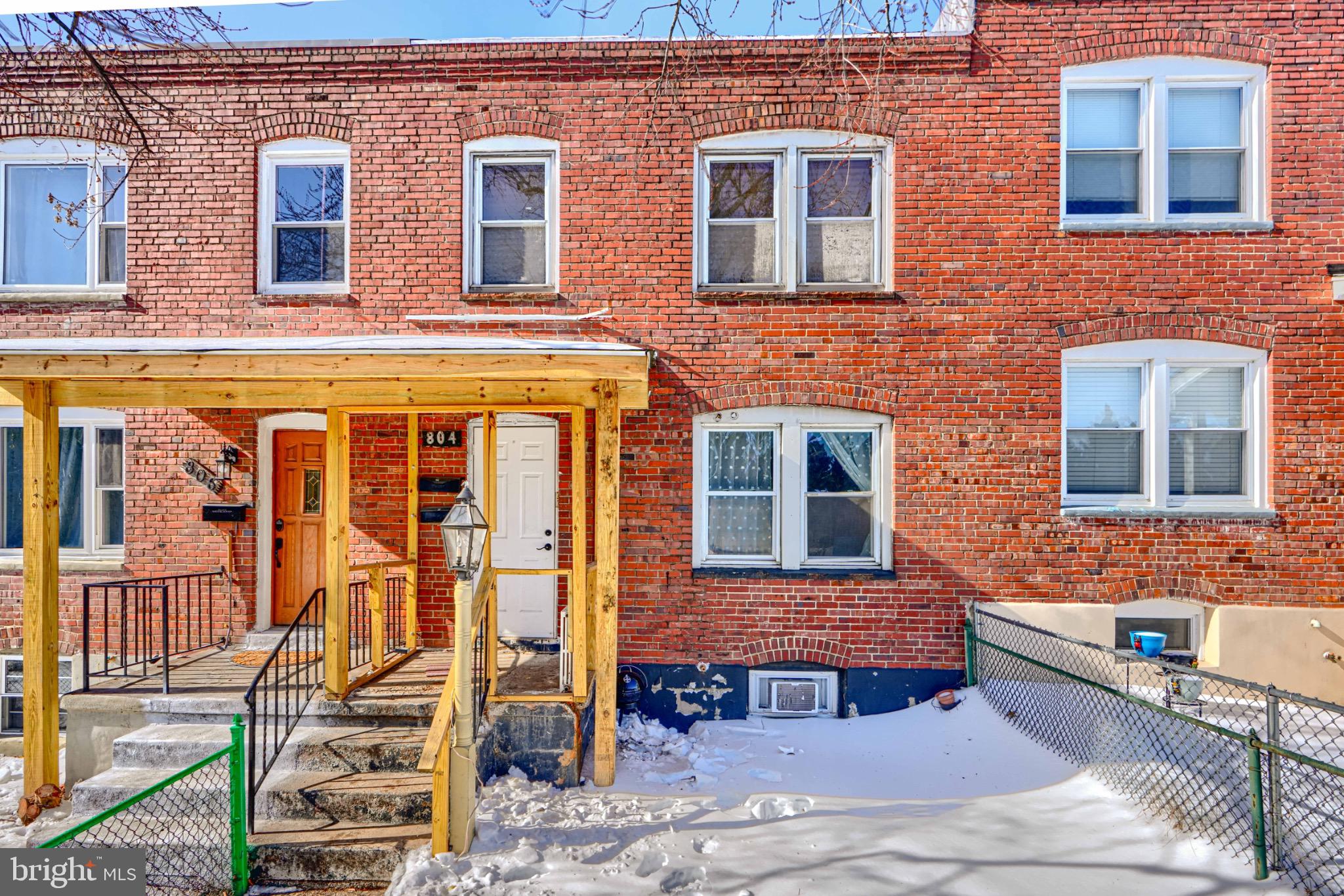 a front view of a brick building with many windows