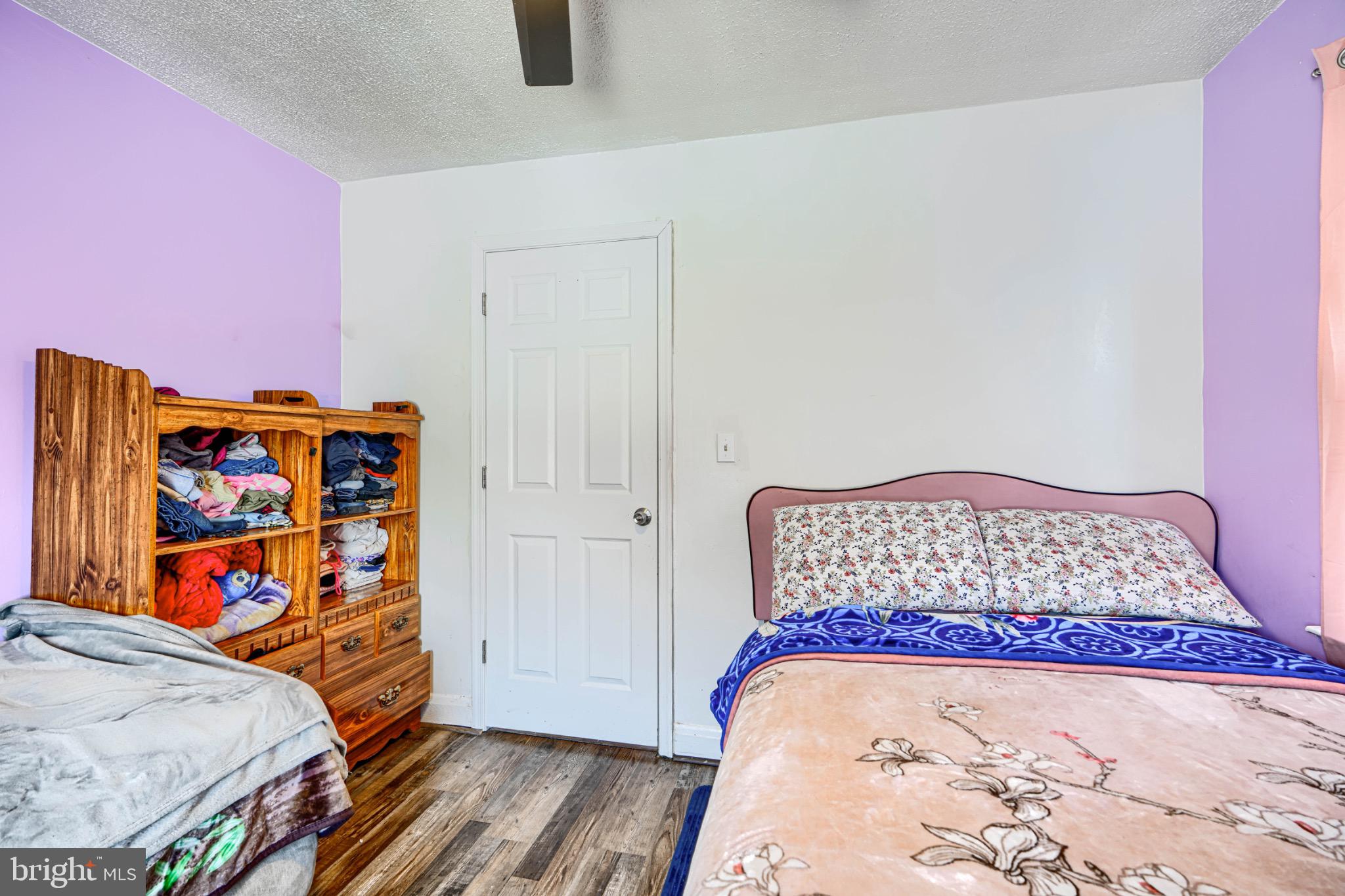 804 Quail Street Baltimore, MD 21224 - Photo 11 of 39 a bedroom with a bed and painting on the wall