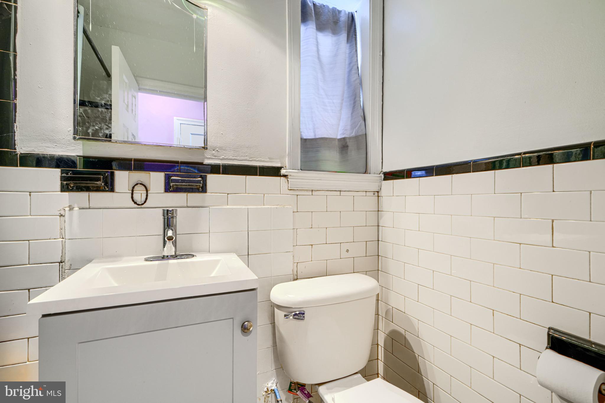 804 Quail Street Baltimore, MD 21224 - Photo 13 of 39 a bathroom with a toilet sink and mirror