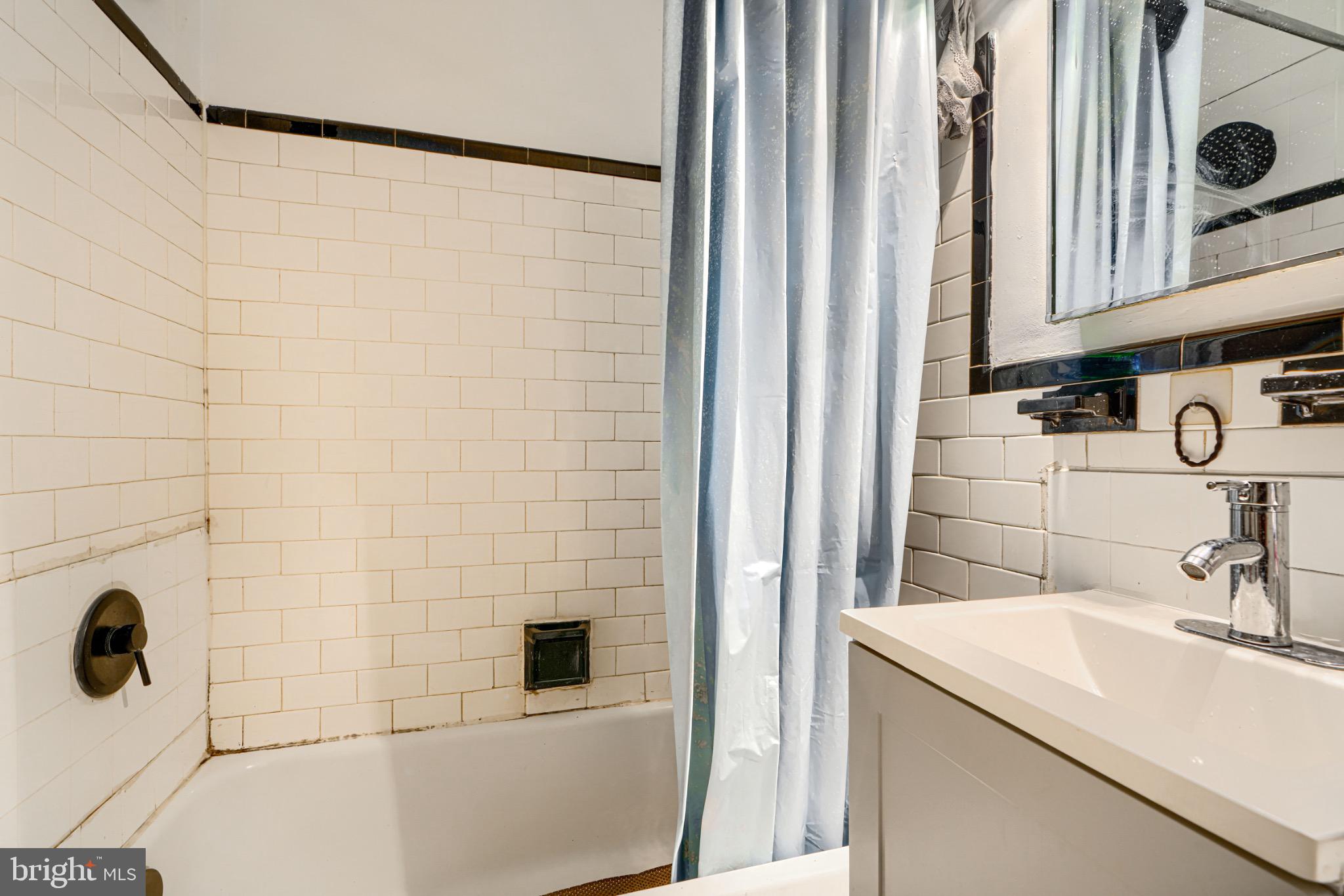 804 Quail Street Baltimore, MD 21224 - Photo 14 of 39 a bathroom with a sink and a mirror