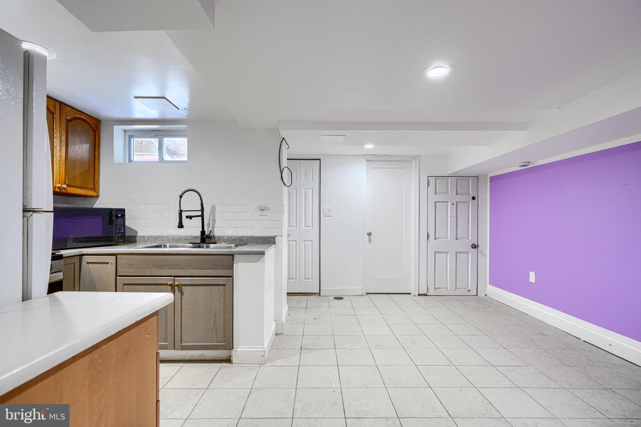 804 Quail Street Baltimore, MD 21224 - Photo 22 of 39 a kitchen with stainless steel appliances a sink stove and cabinets