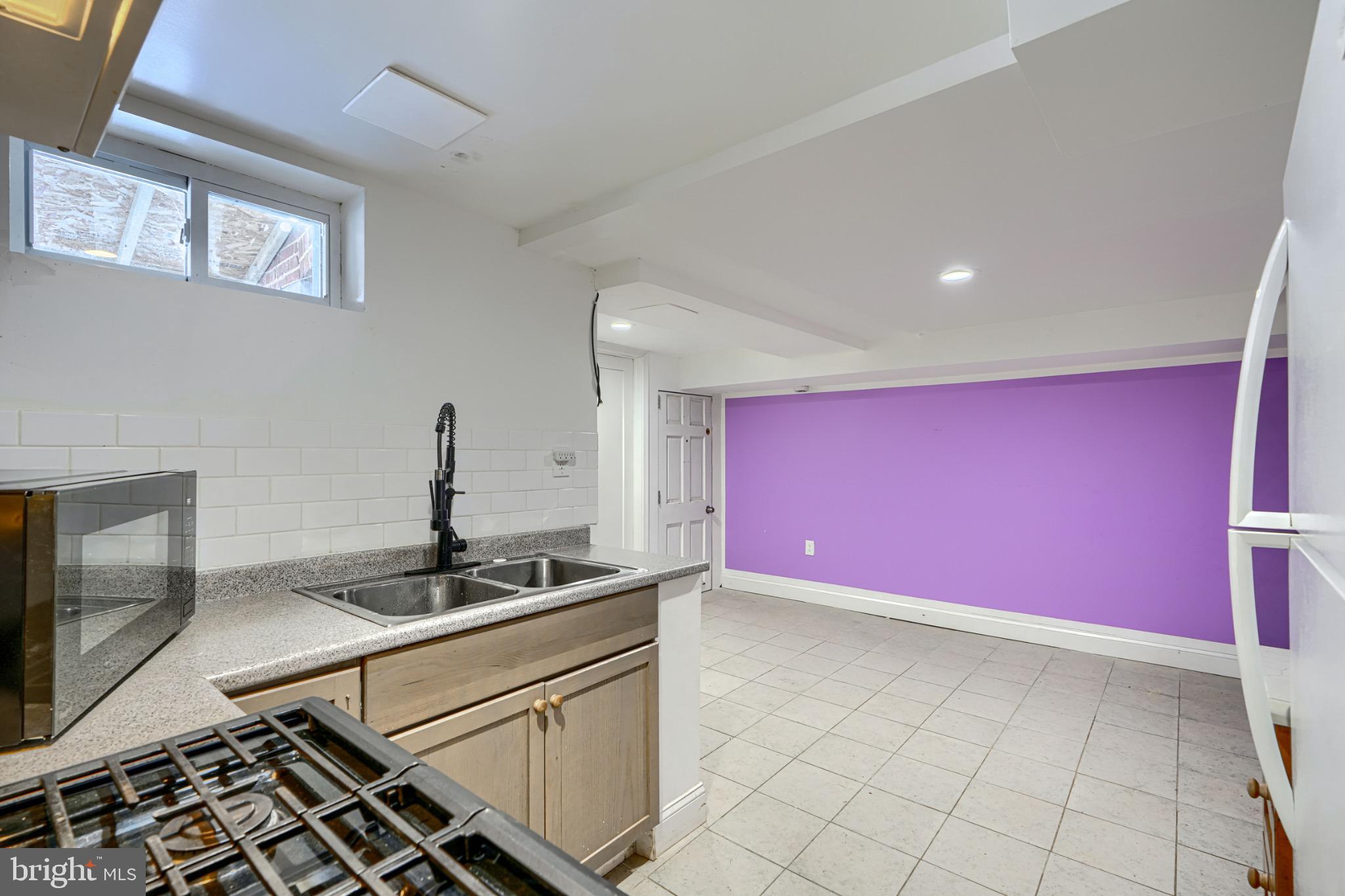 804 Quail Street Baltimore, MD 21224 - Photo 27 of 39 a kitchen with granite countertop a sink and cabinets