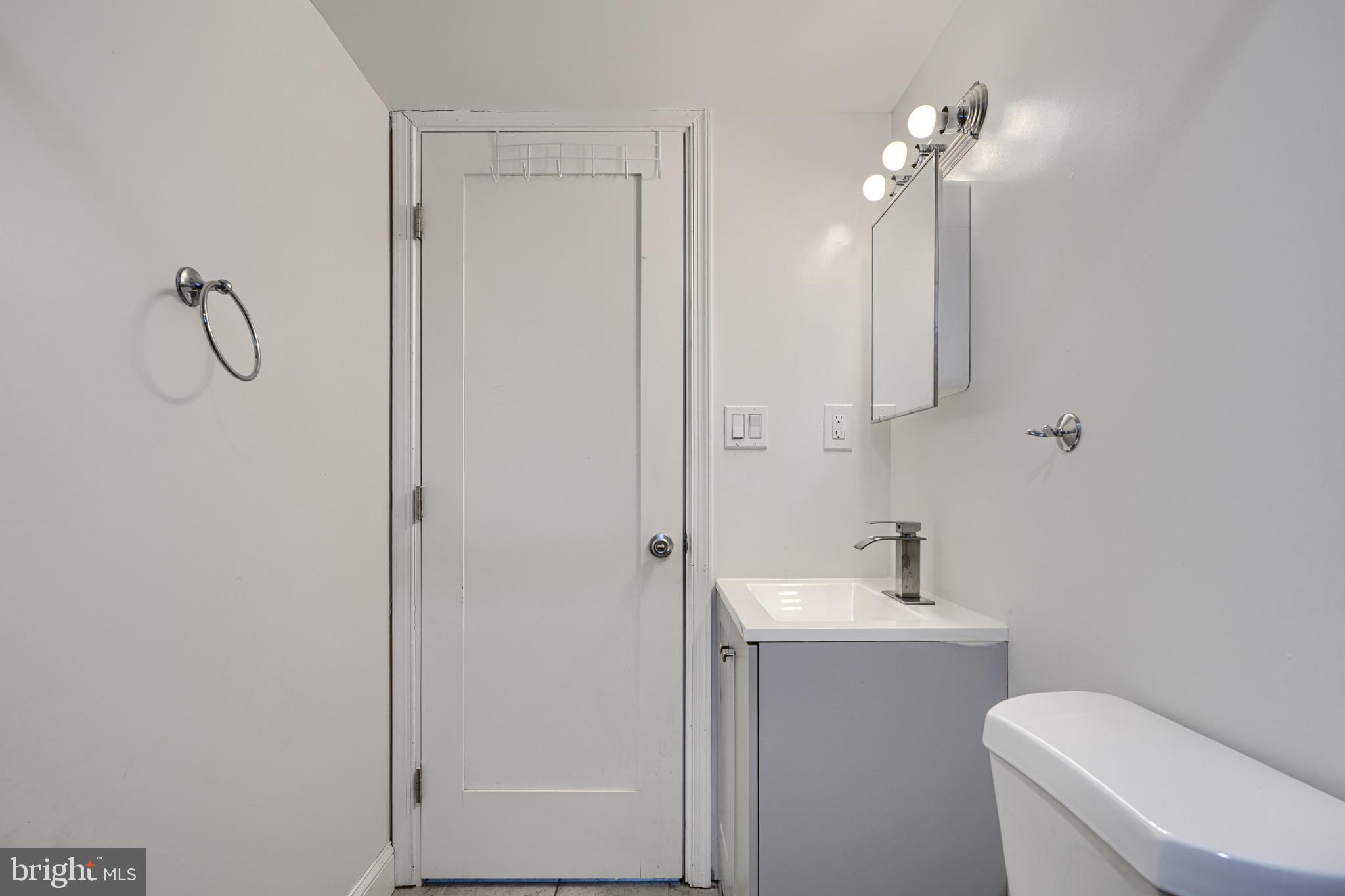 804 Quail Street Baltimore, MD 21224 - Photo 31 of 39 a bathroom with a toilet a sink and shower