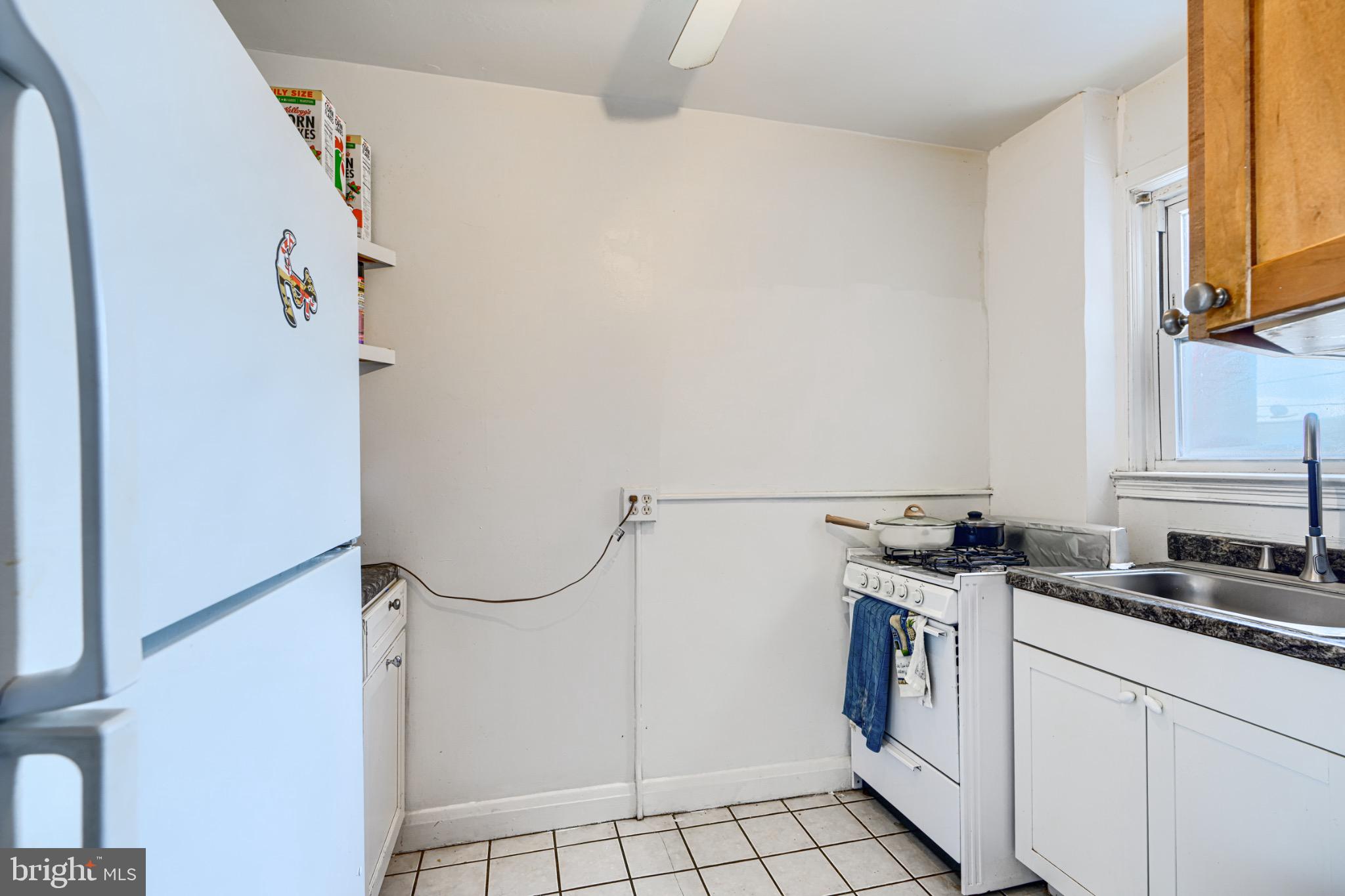 804 Quail Street Baltimore, MD 21224 - Photo 6 of 39 a kitchen with a sink a stove and a refrigerator