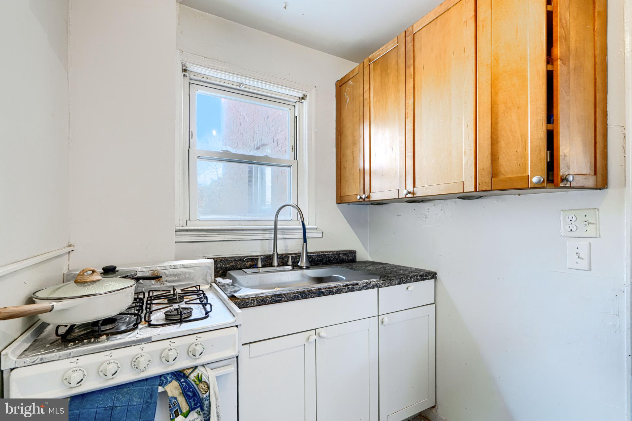 804 Quail Street Baltimore, MD 21224 - Photo 7 of 39 a kitchen with a stove a sink and cabinets
