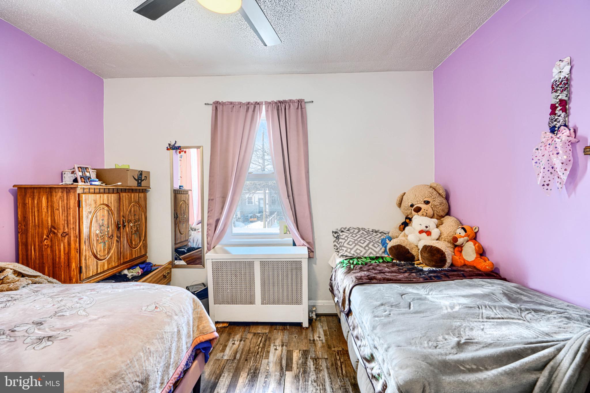 804 Quail Street Baltimore, MD 21224 - Photo 10 of 39 a bed room with a bed and a wooden floor