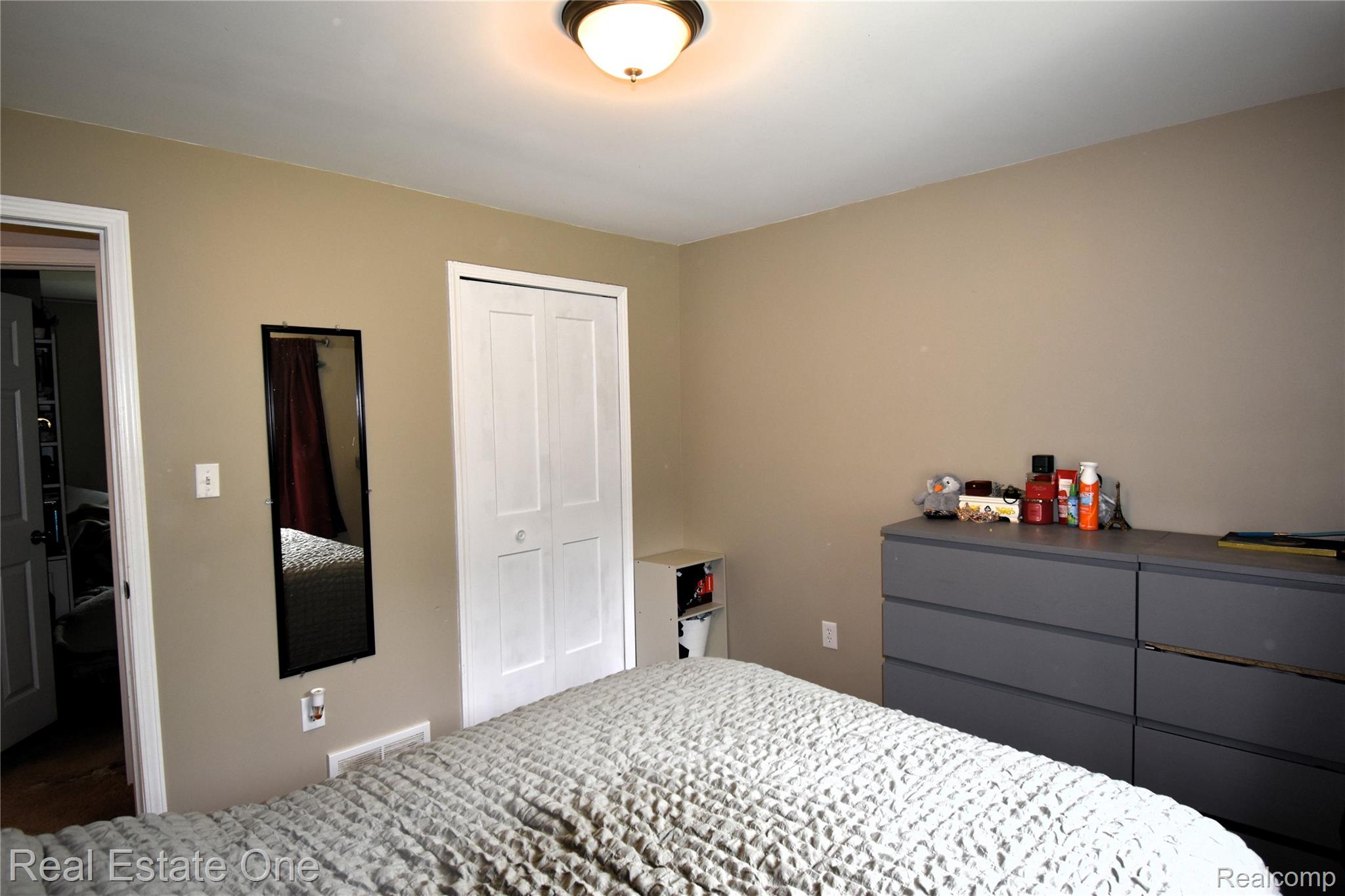 15404 Colbert Street Romulus, MI 48174 - Photo 9 of 23 Neutral-toned walls complement white trim and a ceiling-mounted light fixture