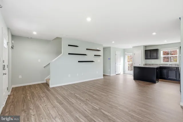 a view of a kitchen with a sink and a refrigerator