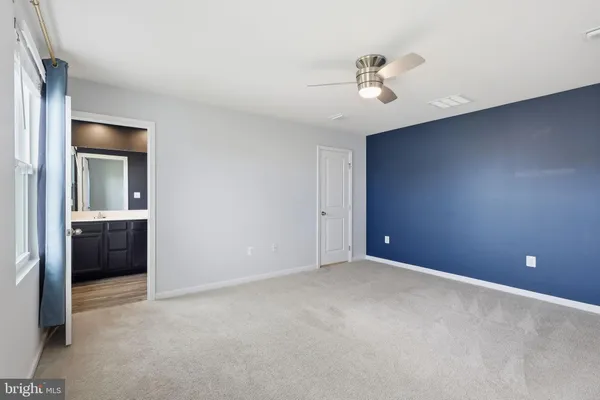 a view of a livingroom with a ceiling fan and window