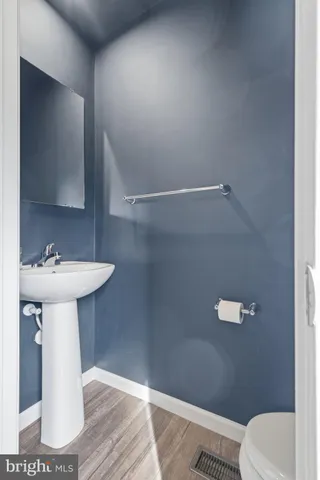 a bathroom with a sink a toilet and mirror