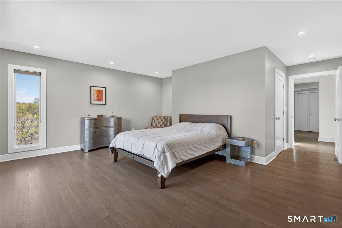 33 Pearl Street Milford, CT 06460 - Photo 17 of 38 a spacious bedroom with a bed and wooden floor