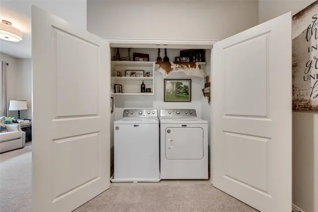 a view of kitchen with refrigerator cabinets and stove top oven