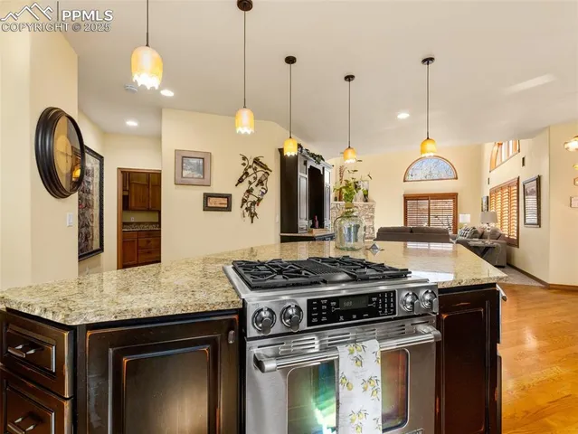 a kitchen with a stove and a chandelier