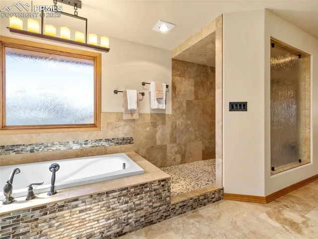 a bathroom with a bathtub and a shower