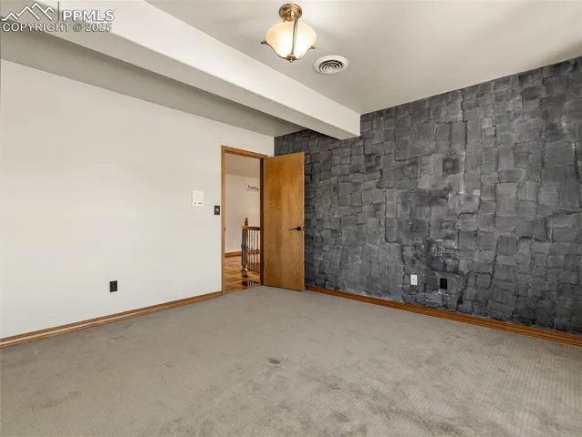 a view of an empty room with a chandelier