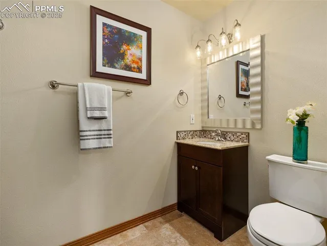 a bathroom with a toilet a sink and mirror