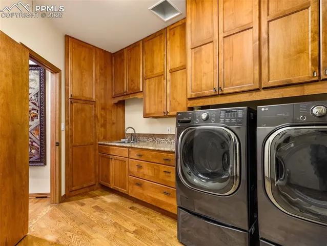 a utility room with sink dryer and washer