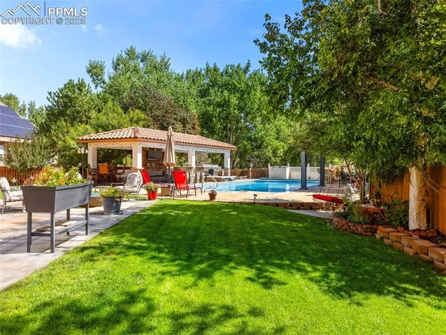 a view of a house with a backyard patio and sitting area
