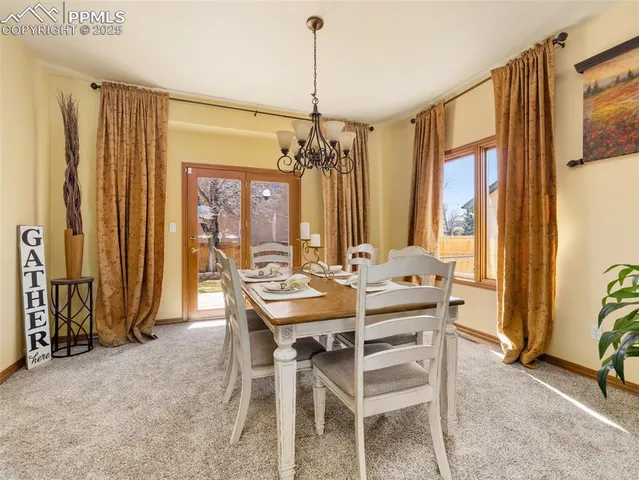 a view of a dining room with furniture and window