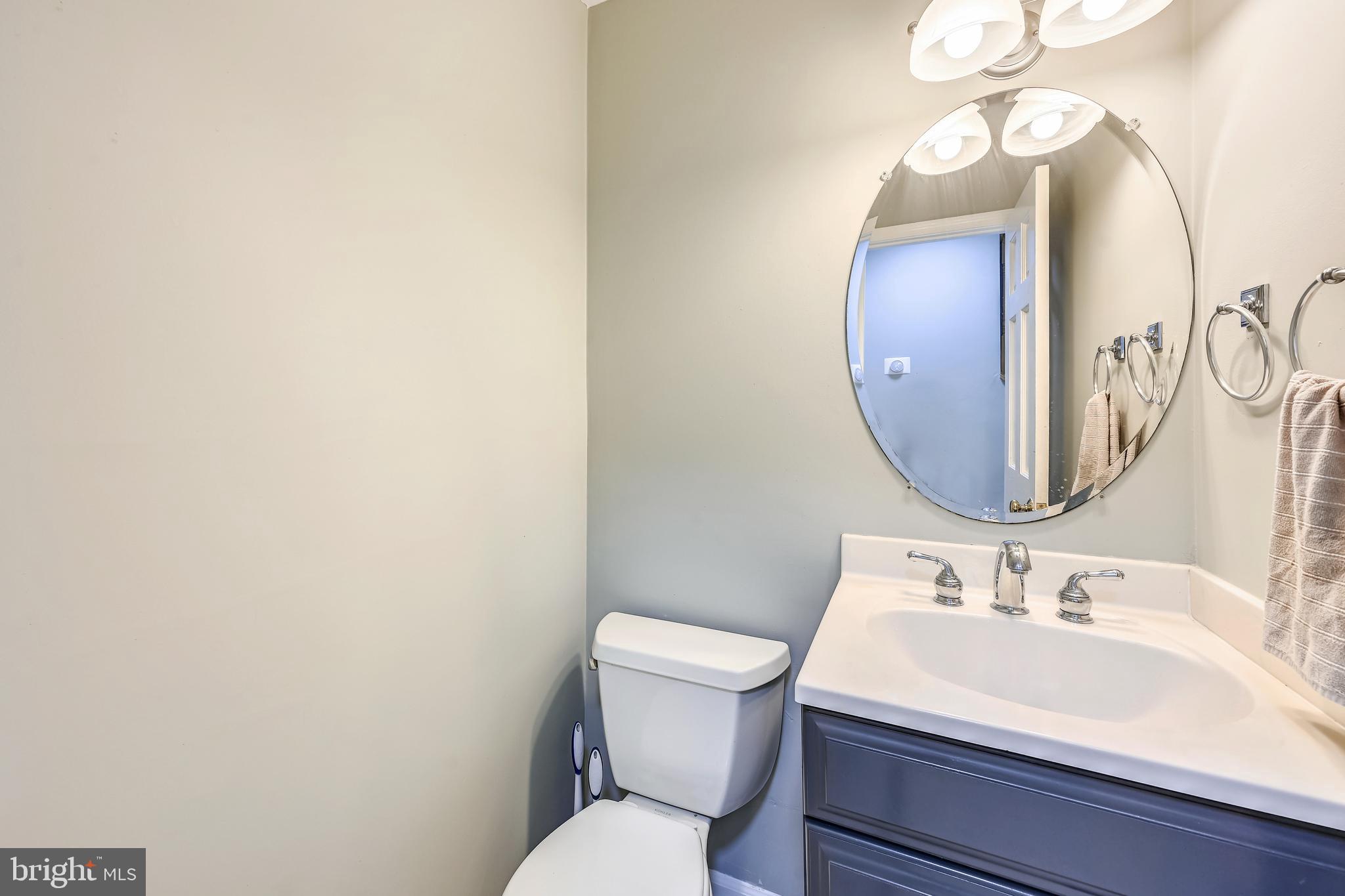 2116 Kings House Road Silver Spring, MD 20905 - Photo 21 of 37 a bathroom with a toilet a sink and mirror