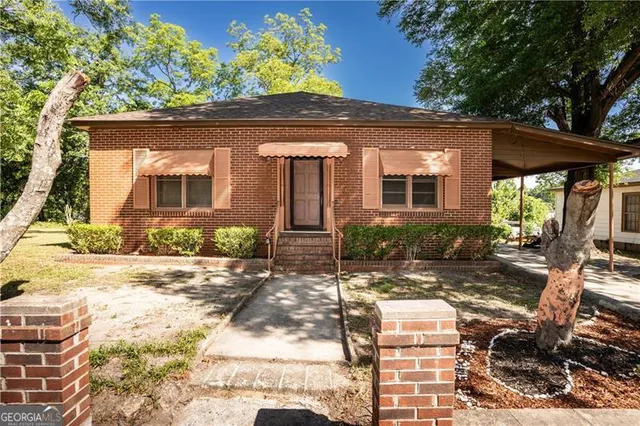 a front view of a house with a yard