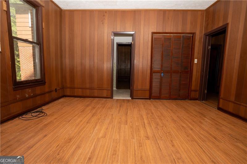 305 Wolfe Street Dublin, GA 31021 - Photo 12 of 27 an empty room with wooden floor and windows