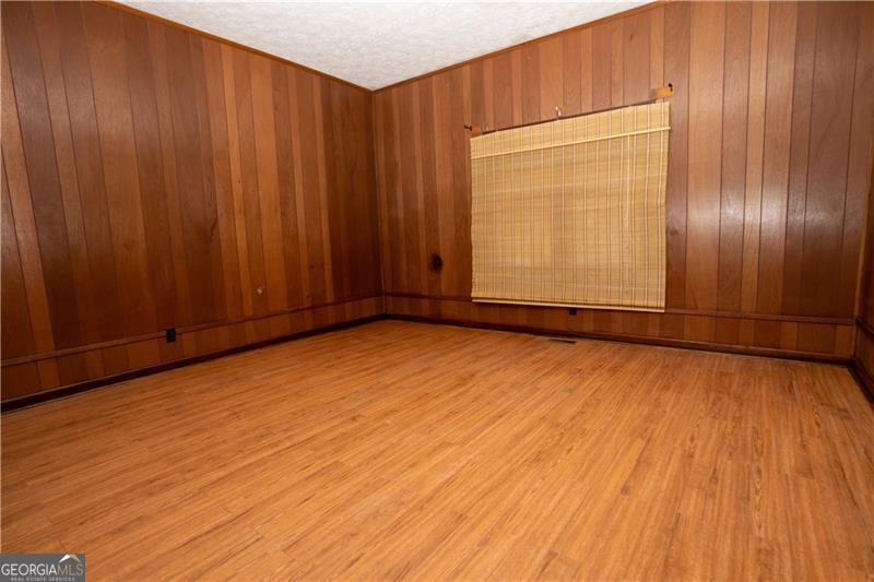 305 Wolfe Street Dublin, GA 31021 - Photo 14 of 27 an empty room with wooden floor and windows