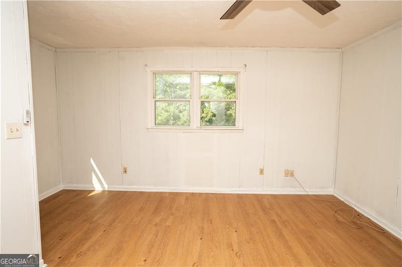 305 Wolfe Street Dublin, GA 31021 - Photo 21 of 27 an empty room with wooden floor and windows