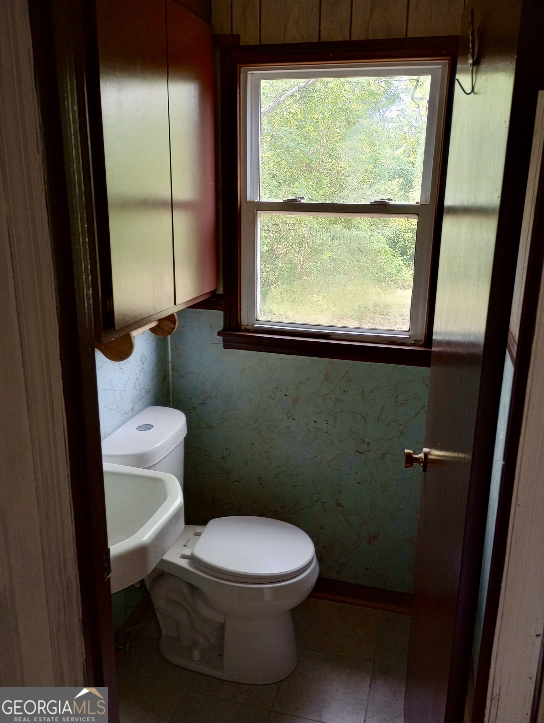 305 Wolfe Street Dublin, GA 31021 - Photo 25 of 27 a bathroom with a toilet a sink and a window