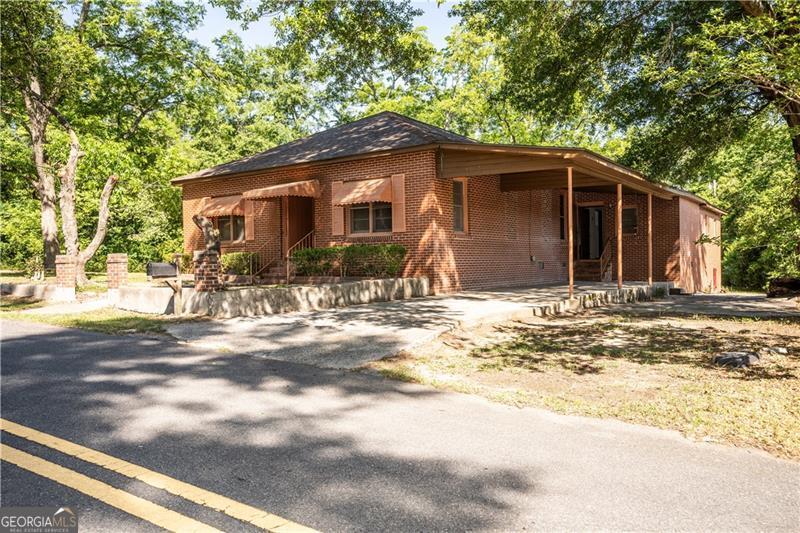 305 Wolfe Street Dublin, GA 31021 - Photo 26 of 27 a backyard of a house with yard and tree