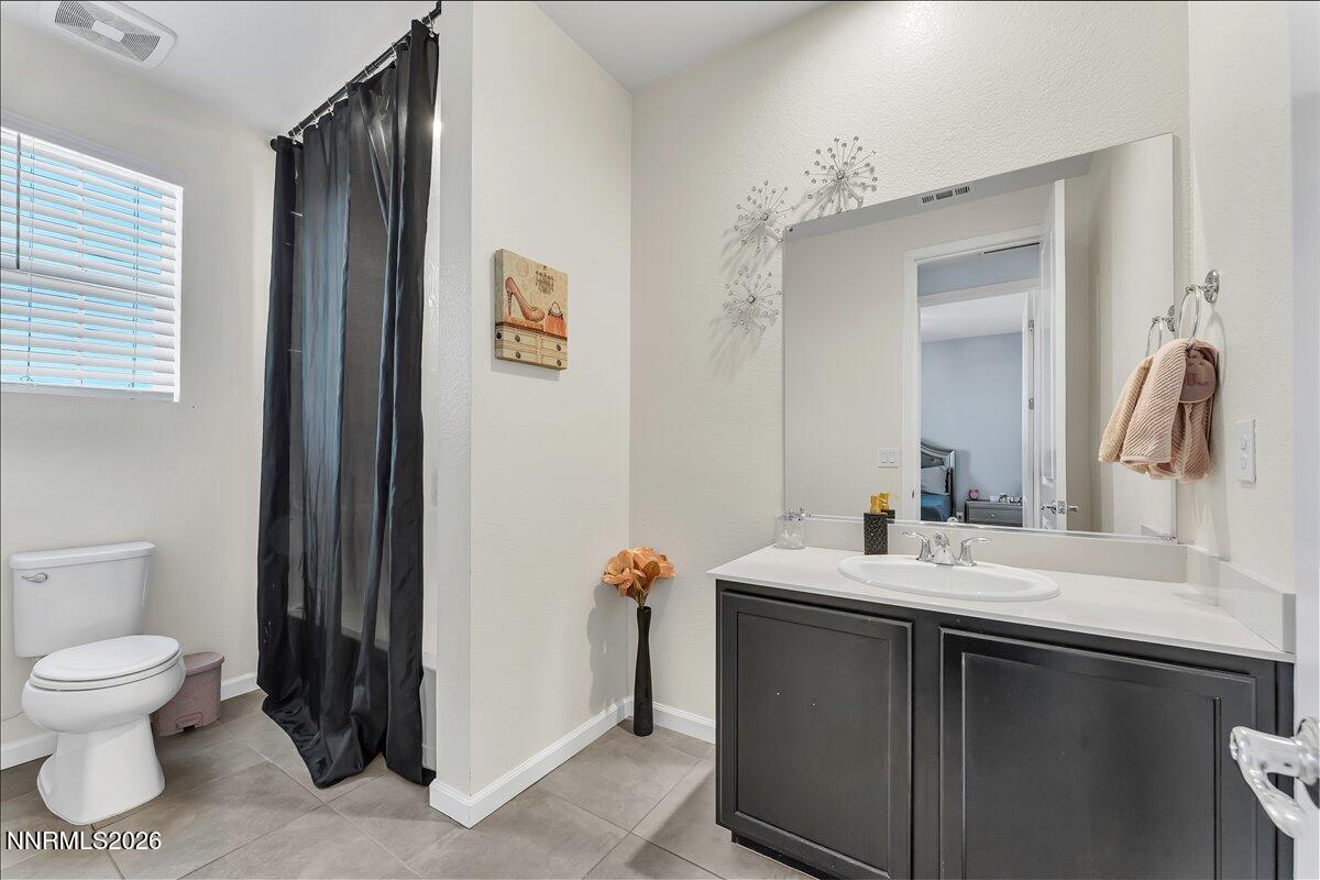 2139 Roaring Fork Court Sparks, NV 89436 - Photo 18 of 42 a bathroom with a sink toilet and mirror
