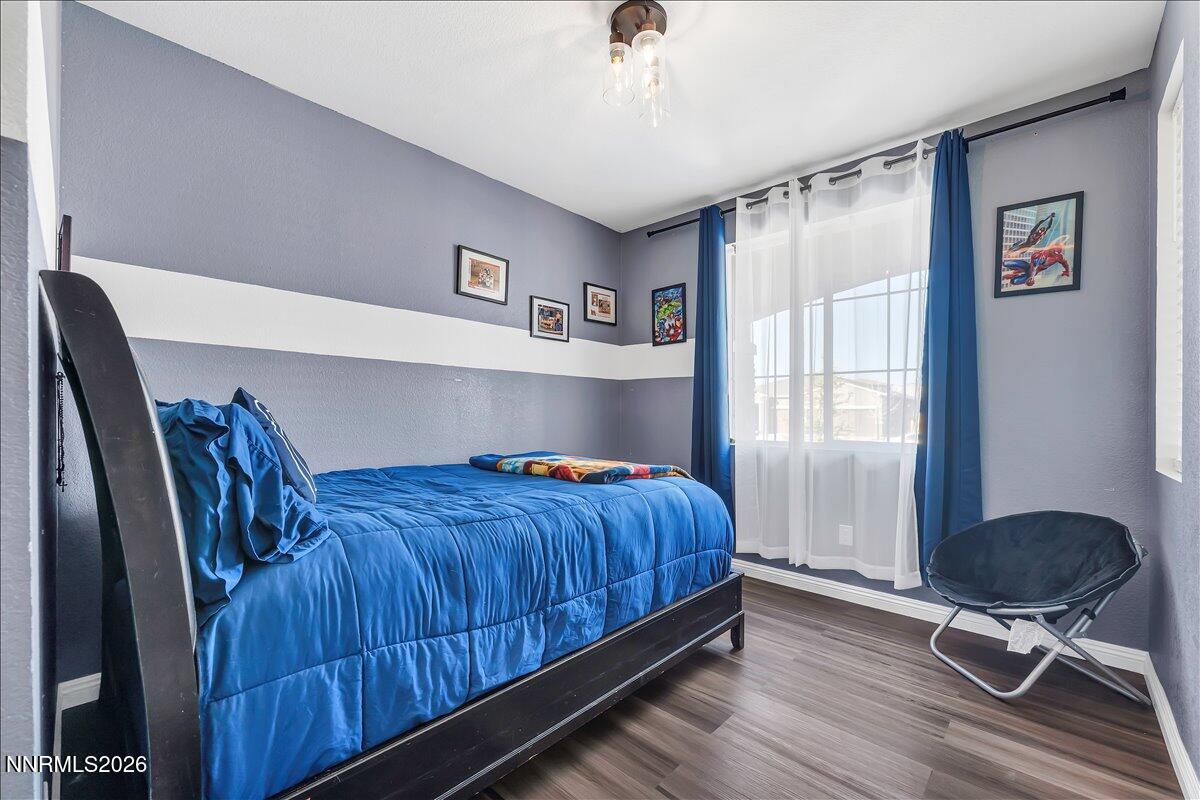 2139 Roaring Fork Court Sparks, NV 89436 - Photo 19 of 42 a bedroom with a bed and a chair in it
