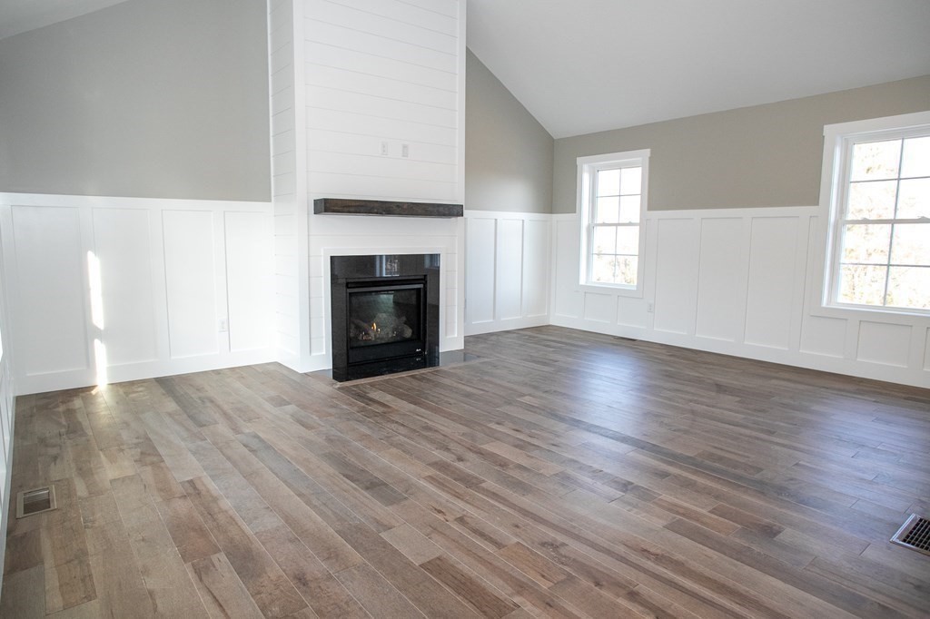 38 D Edson Road Oakham, MA 01068 - Photo 13 of 36 an empty room with wooden floor fireplace and windows