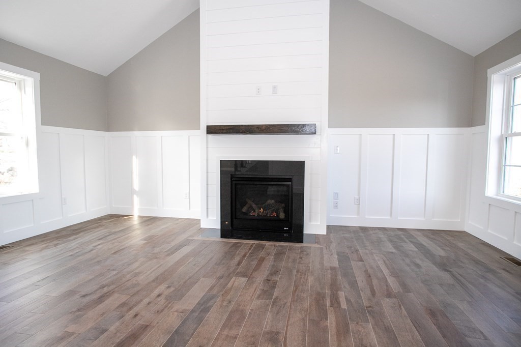 38 D Edson Road Oakham, MA 01068 - Photo 15 of 36 a view of an empty room with wooden floor fireplace and a window