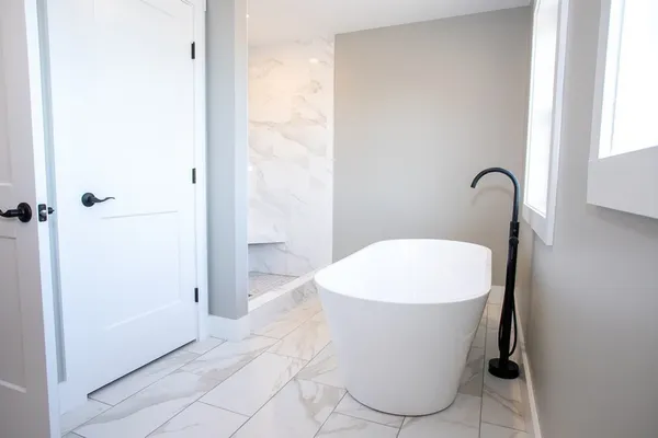 a white bath tub sitting in a bathroom