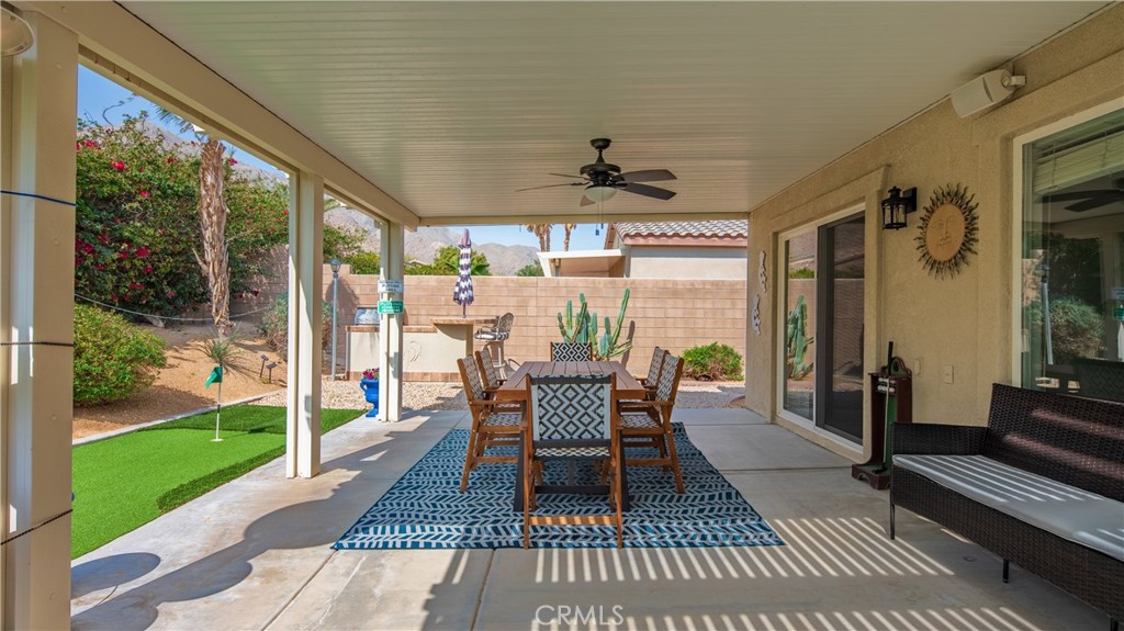 1171 Palmas Ridge Palm Springs, CA 92262 - Photo 14 of 75 Misters are attached to the ceiling edge to keep the area fresh and cool on the private porch and putting green!