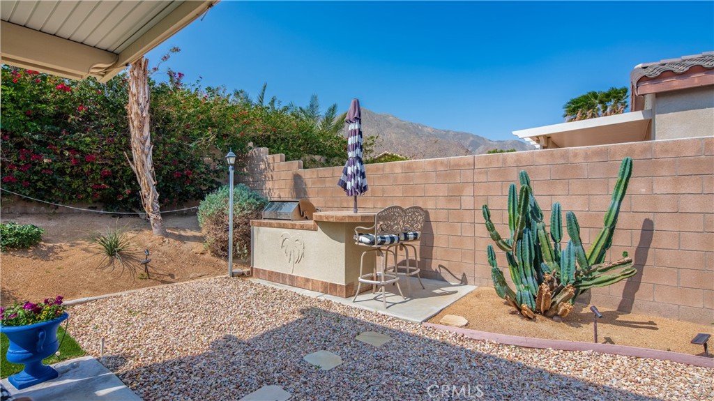 1171 Palmas Ridge Palm Springs, CA 92262 - Photo 17 of 75 Barbeque area well designed for friends to perch while you are grilling and nice stone gravel work and cactus surrounding you!