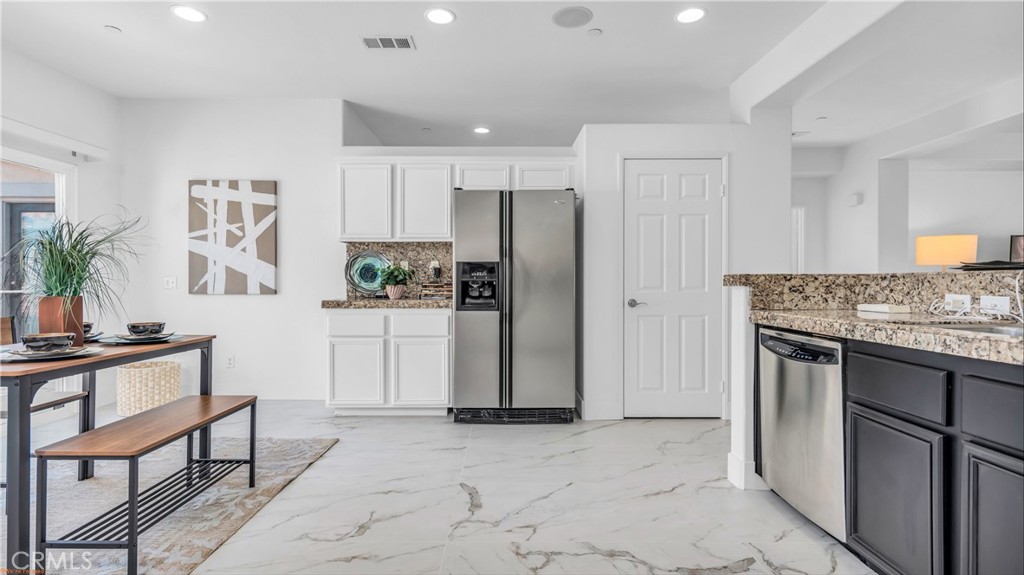 1171 Palmas Ridge Palm Springs, CA 92262 - Photo 21 of 75 Breakfast area looks out on courtyard which is landscaped beautifully!! Walk in pantry to right of refrigerator and second pantry in kitchen by laundry room entrance.