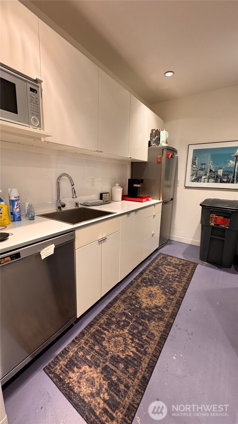 2901 Northeast Blakeley Street, Unit 3A Seattle, WA 98105 - Photo 5 of 8 a kitchen with a sink and cabinets