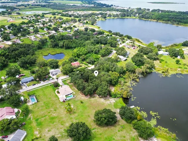 an aerial view of a houses with a lake view