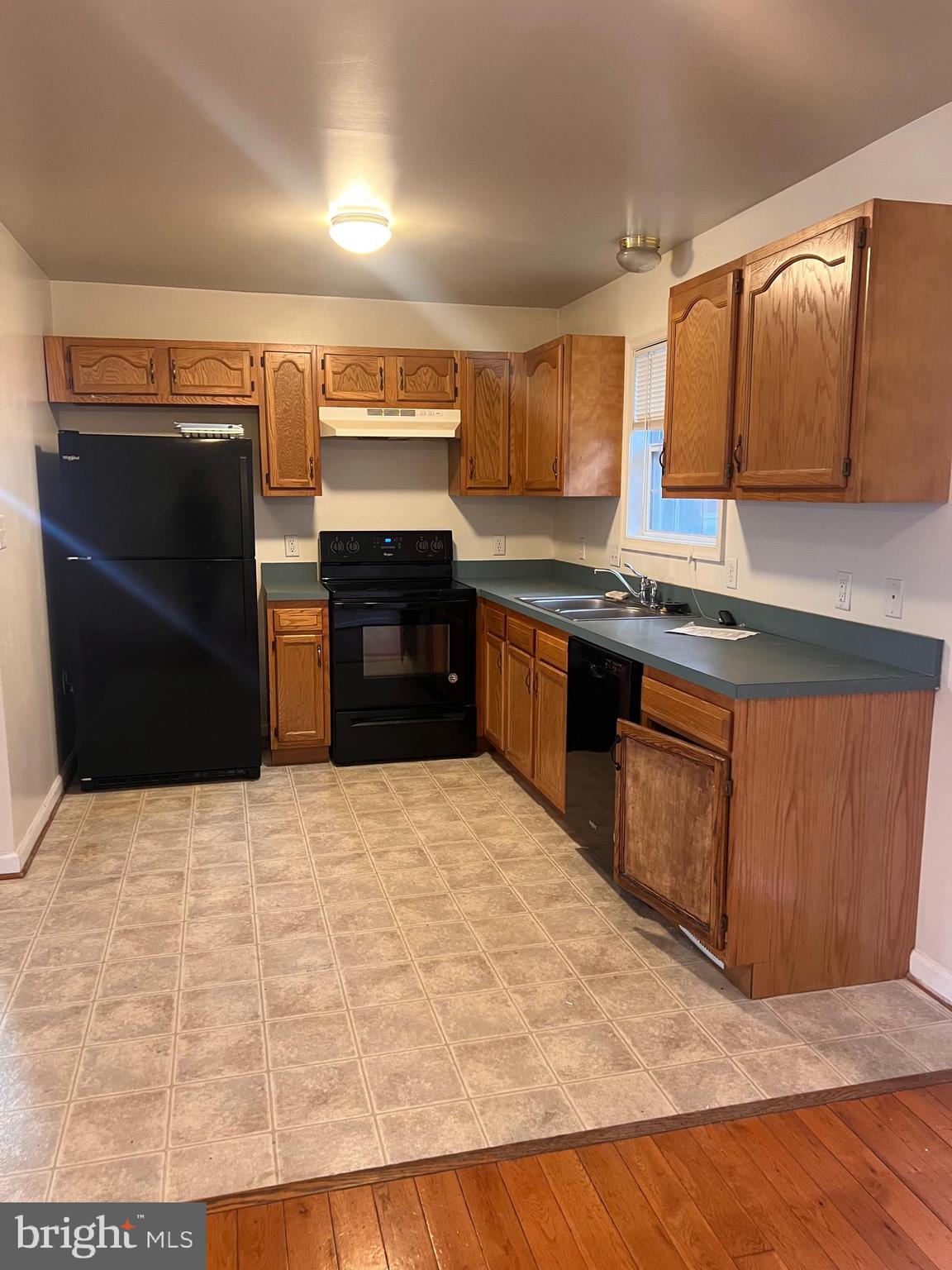 121 North Marshall Street Ranson, WV 25438 - Photo 8 of 17 a large kitchen with kitchen island granite countertop wooden cabinets a refrigerator and a sink