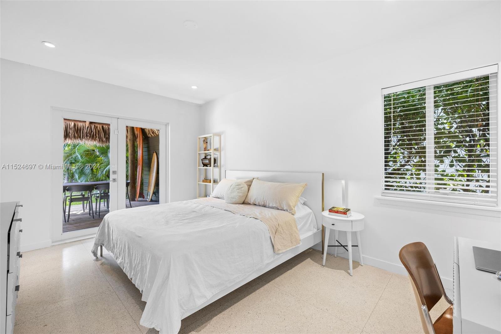 1310 Cleveland Road Miami Beach, FL 33141 - Photo 12 of 33 a bedroom with a bed a mirror and a large window