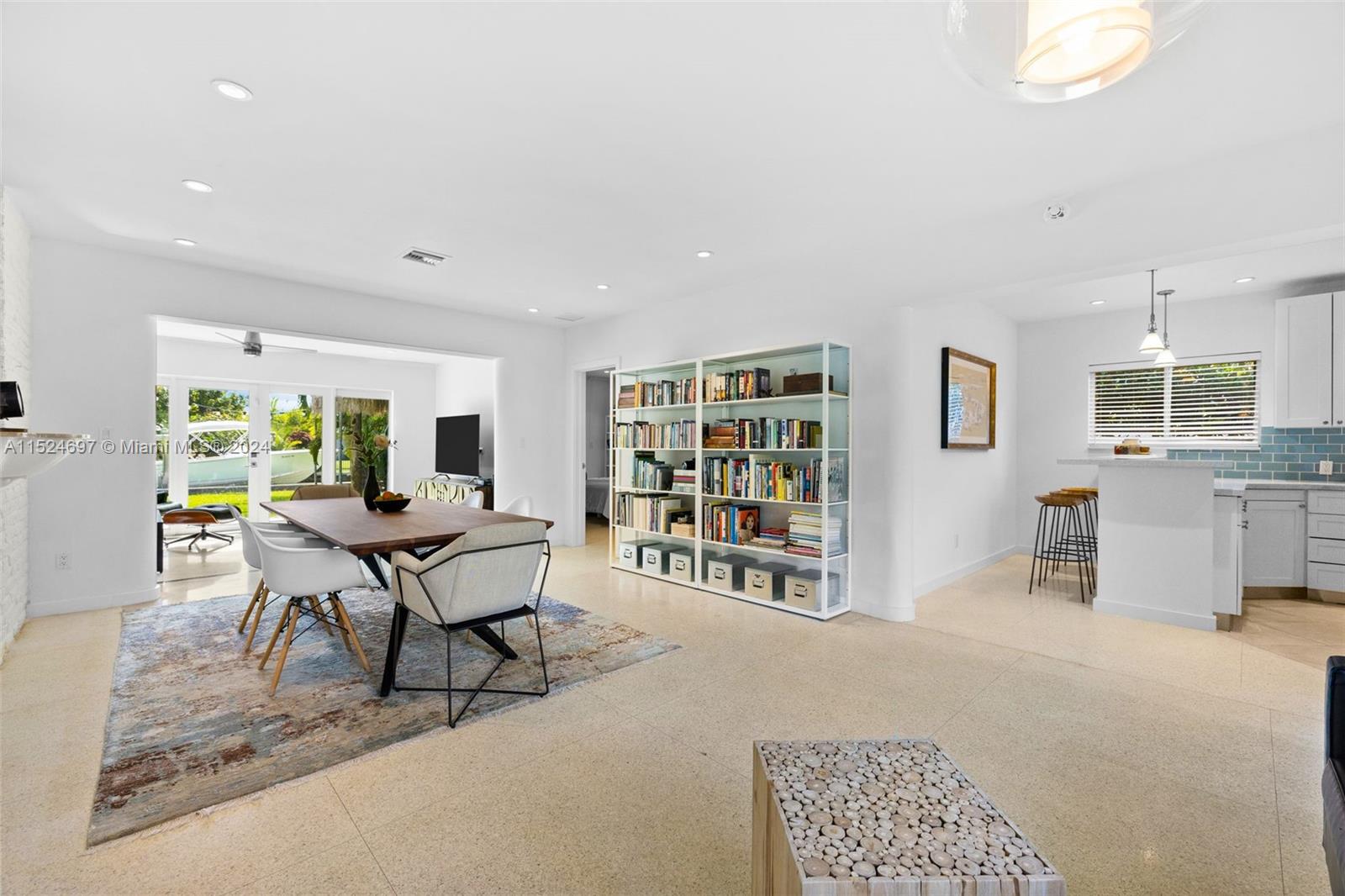 1310 Cleveland Road Miami Beach, FL 33141 - Photo 3 of 33 a living room with furniture a bookshelf and wooden floor