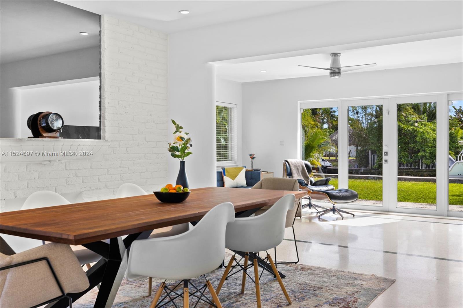 1310 Cleveland Road Miami Beach, FL 33141 - Photo 4 of 33 a view of a dining room with furniture large windows and wooden floor