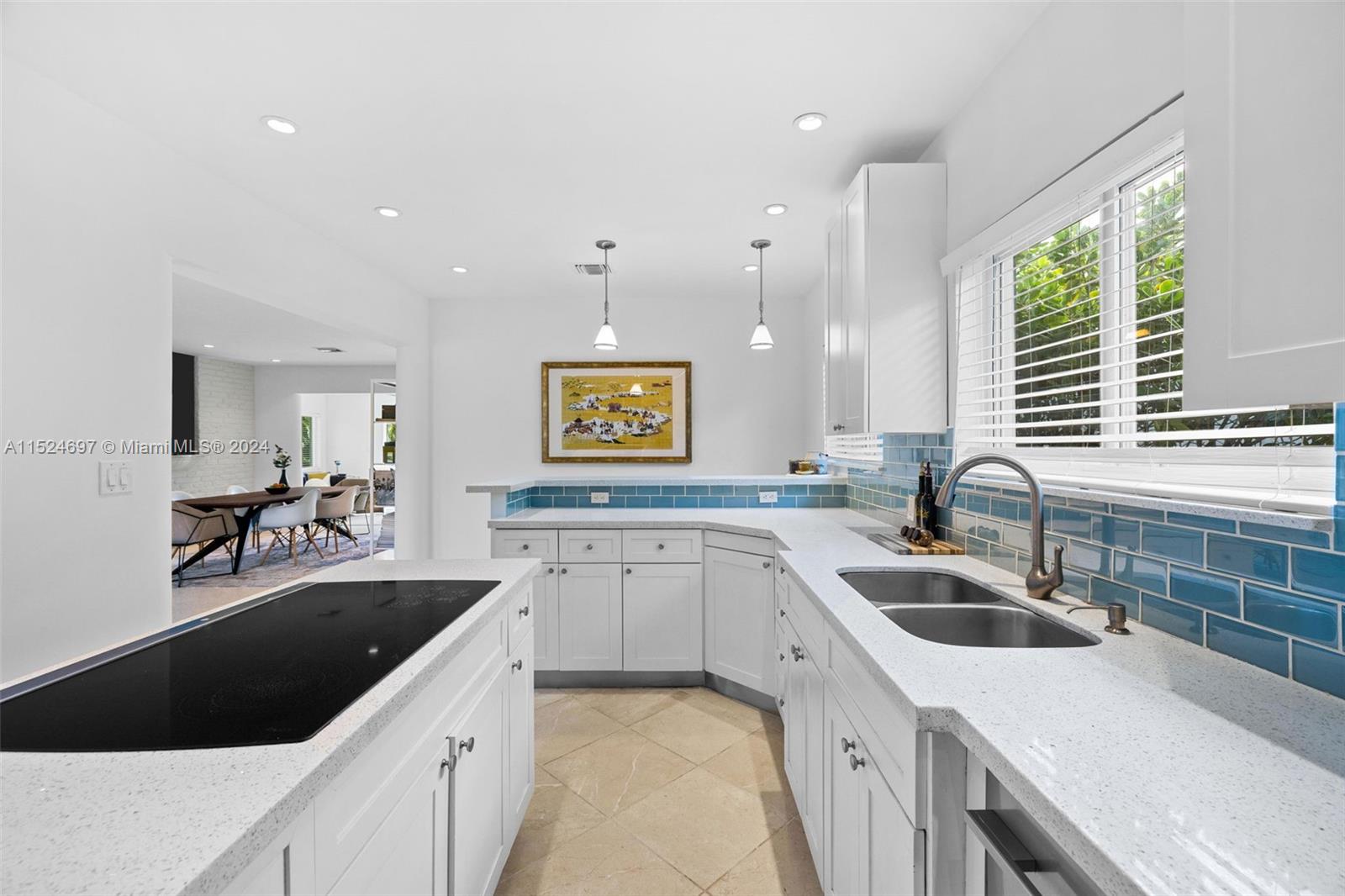 1310 Cleveland Road Miami Beach, FL 33141 - Photo 8 of 33 a kitchen with a sink a stove and cabinets