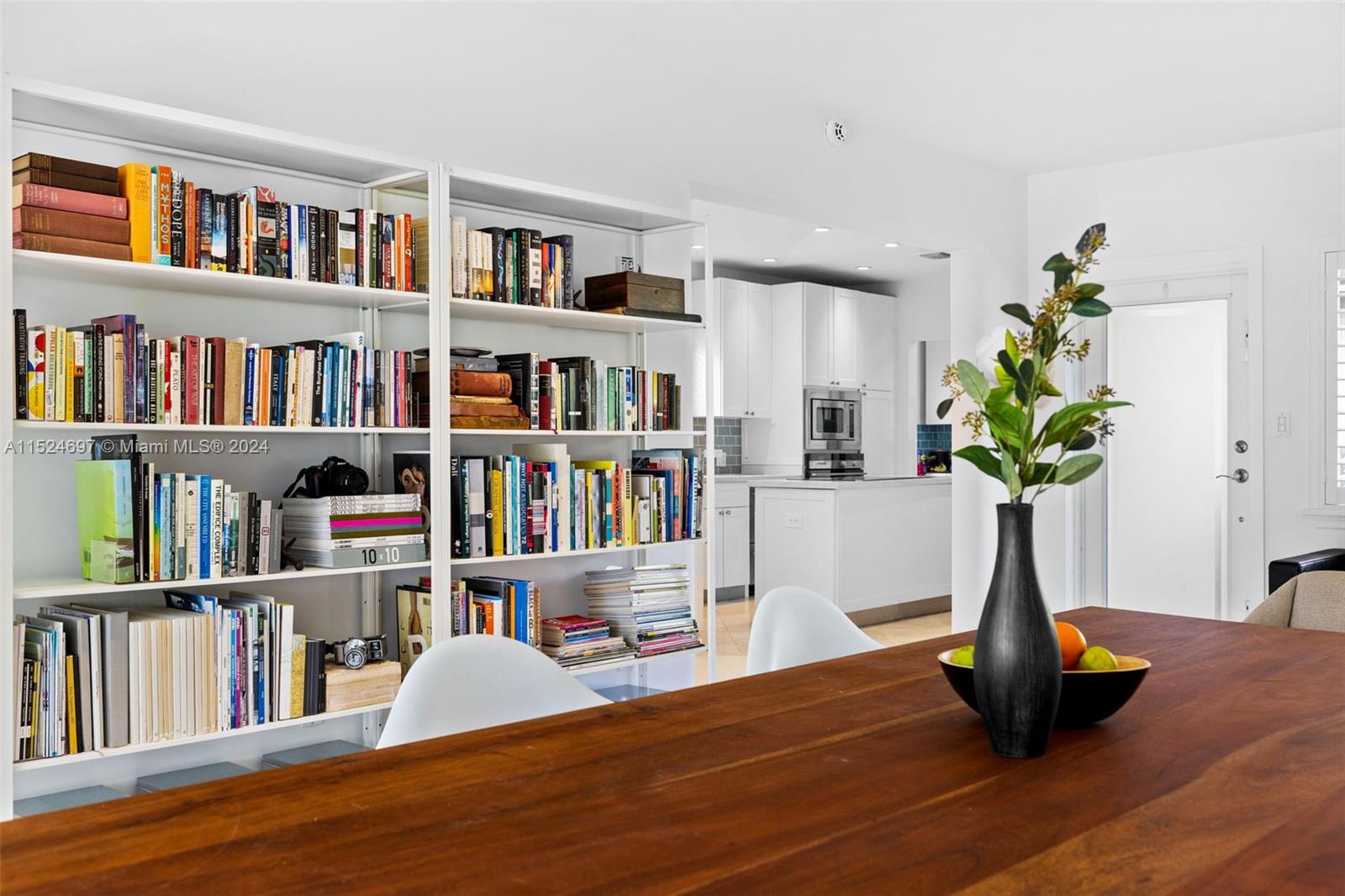 1310 Cleveland Road Miami Beach, FL 33141 - Photo 9 of 33 a view of room with book shelf and book shelf