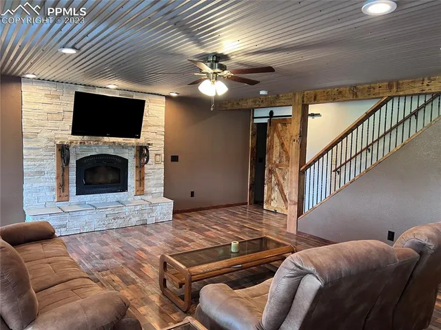 a living room with furniture and a fireplace