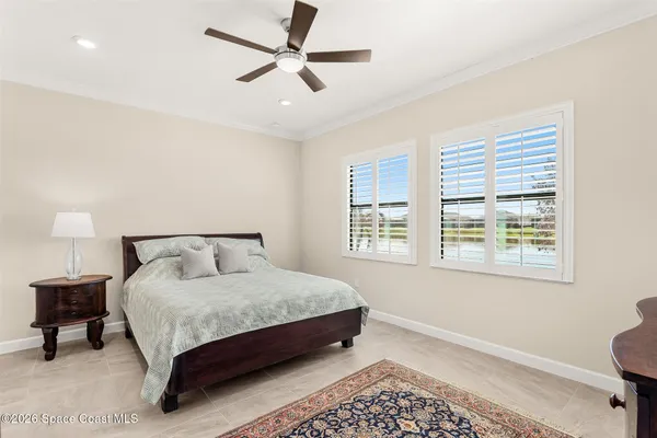 a large bed sitting in a bedroom next to a window