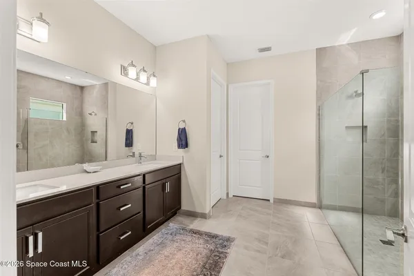 a spacious bathroom with a granite countertop sink mirror and double