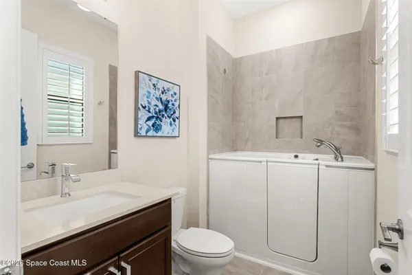 a bathroom with a sink toilet and vanity
